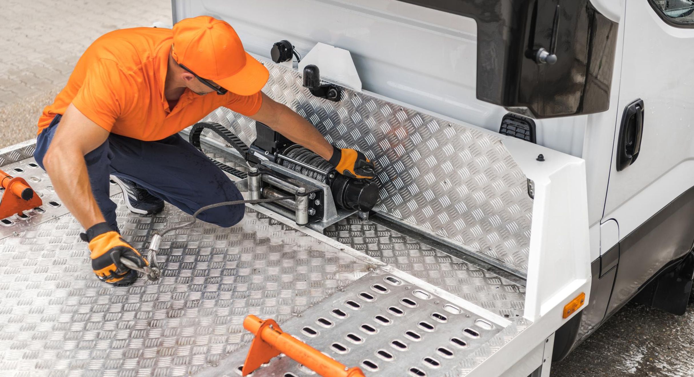 Man installing tow
					rope on truck